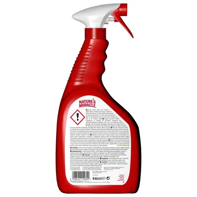 Back of Nature's Miracle spray bottle showing warning symbol, caution text, ingredients list and 946ml volume.