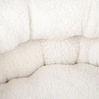 Close-up of white, soft plush material with textured surface.