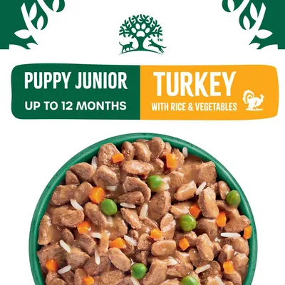 Puppy junior food for up to 12 months, turkey with rice and vegetables. Image shows bowl of food with meat chunks, peas, carrots and rice in gravy.