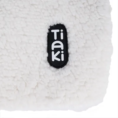 Tiaki logo on white, fluffy material.