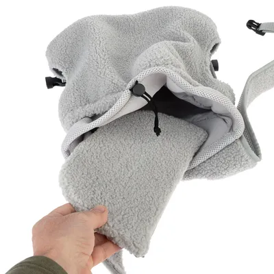 Sac en tissu polaire gris avec cordon de serrage, intérieur matelassé et fond amovible tenu par une main. Sangle visible sur le côté.