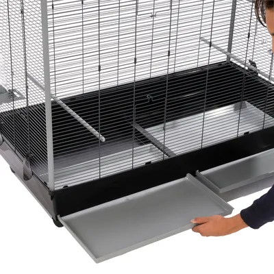 Cage with pull-out plastic tray for easy cleaning. Metal grid and stable construction visible.