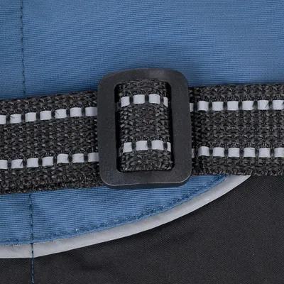 Close-up of a black, adjustable strap with reflective stripes on blue fabric.