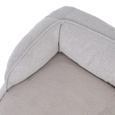 Close-up of a grey pet bed with soft padding and fabric cover.