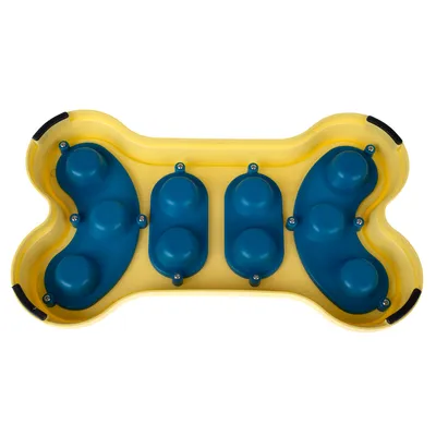 Plateau en forme d’os, plastique jaune et bleu, avec plusieurs compartiments ronds visibles sur le dessus. Aucun texte ou marque apparente.