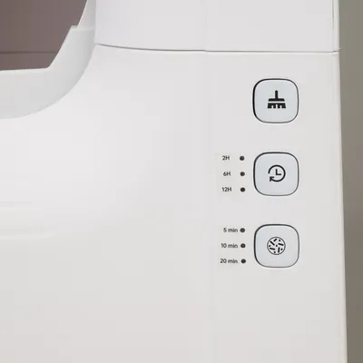 Control panel with three buttons: cleaning symbol, timer for 2h, 6h, 12h, and ventilation settings for 5 min, 10 min, 20 min.