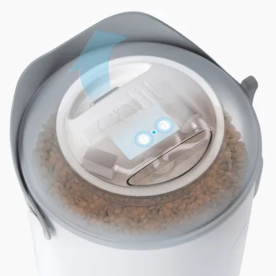 Catit food container with airtight seal and arrow indicating air circulation. Visible dry food filling inside.