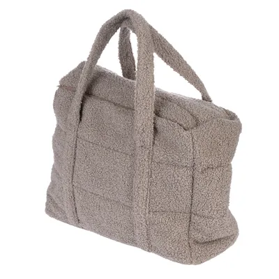 Sac en tissu bouclé beige avec deux anses, fermeture zippée visible sur le dessus. Aucun logo ou texte apparent.