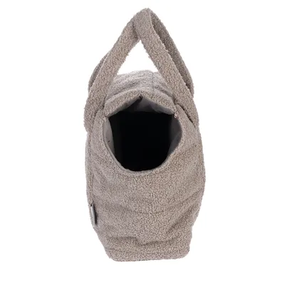 Sac de transport en tissu beige à texture bouclée, ouverture sur le dessus et deux anses visibles. Aucun animal ni marque apparente.