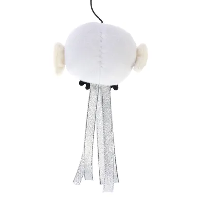 Hanging toy made of white fabric with silver ribbons and black accents.