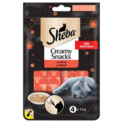 Sheba Creamy Snacks mit Rind au Boeuf, NEU NOUVEAU, 4 x 12 g. Kuvassa harmaa kissa ja annos tahnamaista herkkua. Pakkauksessa kuvake käsin syötettävästä herkusta.
