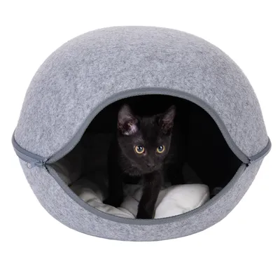 Grå katthåla av filt med dragkedja, vitt kudde inuti. Svart katt tittar ut genom öppningen.