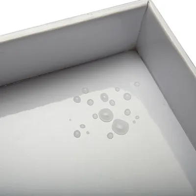 Close-up of water droplets on a smooth tray surface, showing its water-resistant or easy-clean feature.