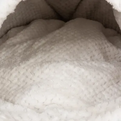 Close-up of soft, white plush material with textured surface, suitable for pet beds or blankets.