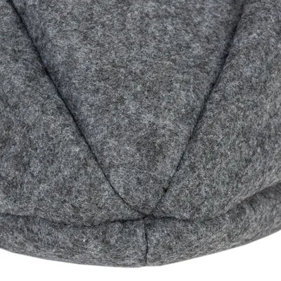 Close-up of grey felt material with visible seams, possibly part of a pet product.