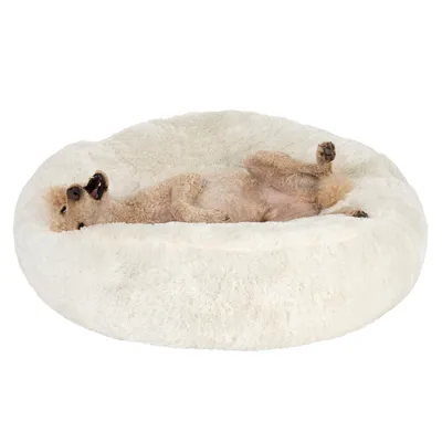 Animal lying comfortably on a large, round, fluffy white bed, demonstrating use of the product for relaxation or rest.