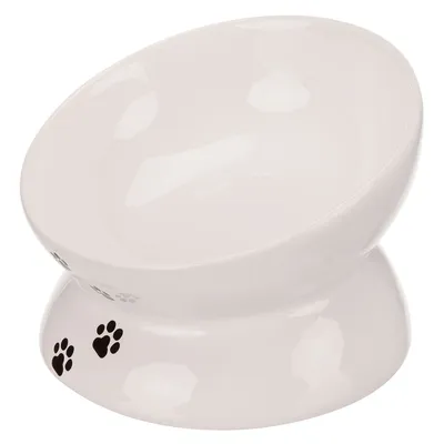 White ceramic feeding bowl with elevated base and black paw prints as decoration.