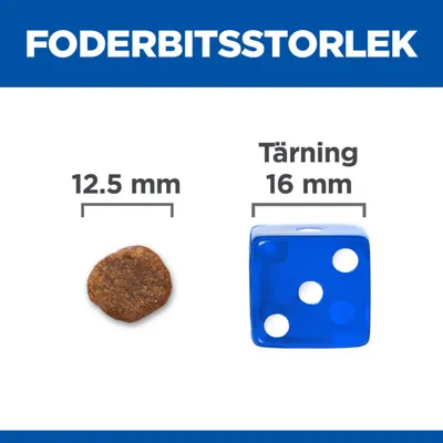 Foderbitsstorlek: foderbit 12,5 mm bredvid blå tärning 16 mm. Jämförelse av storlek mellan foderbit och tärning.