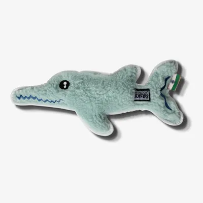 Soft plush toy shaped like a crocodile with stitched details and a visible brand label on its side.