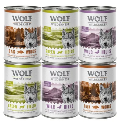 Six cans labelled Wolf of Wilderness in three varieties: Oak Woods, Green Fields, and Wild Hills. Each can states 100% grain-free and contains 400g.