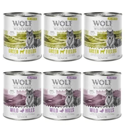6 conserve Wolf of Wilderness Senior, 3 Green Fields cu pui și miel, 3 Wild Hills cu rață și vițel, 800g fiecare. Text vizibil: 100% grain free recipe, free-range meat.