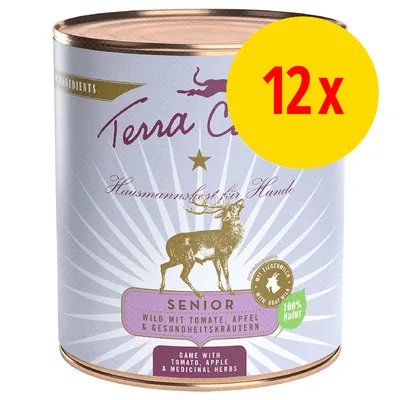 Terra Canis Senior hundemad, vildt med tomat, æble og sundhedsurter. 12 x dåser. Synlig tekst: '100 % Natur', 'Hausmannskost für Hunde', 'Game with tomato, apple & medicinal herbs'. Terra Canis Senior hundemad, vildt med tomat, æble og sundhedsurter. 12 x dåser. Synlig tekst: '100 % Natur', 'Hausmannskost für Hunde', 'Game with tomato, apple & medicinal herbs'.