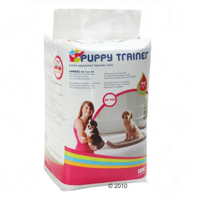 Verpakking Savic Puppy Trainer super absorberende trainingsmatten, large 60 x 45 cm, 50 stuks. Afbeelding van puppy’s en mat. Oppervlak droogt in 30 seconden.