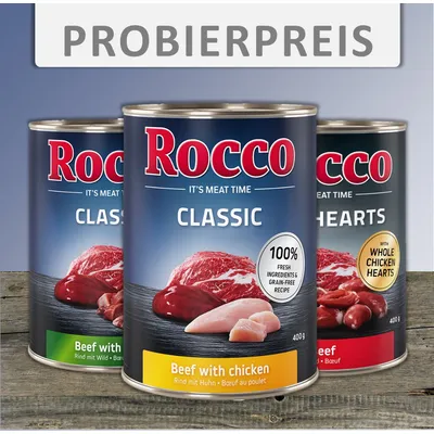 Tri konzerve Rocco pseće hrane: Classic Beef with chicken 400 g, Classic Beef with game, Classic Hearts with whole chicken hearts. Tekst na njemačkom: PROBIERPREIS.
