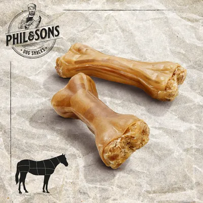 Phil & Sons Dog Snacks. Zwei Kauknochen aus Pferdehaut, geeignet für Hunde. Illustration zeigt Fleischzuschnitt eines Pferdes.