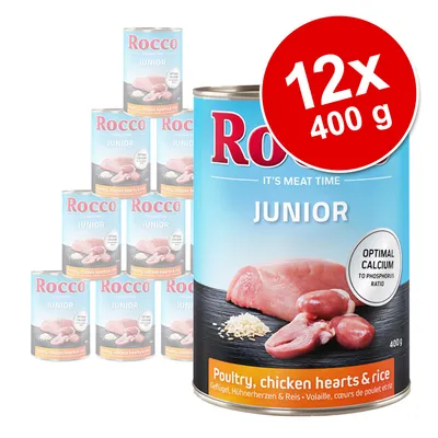 Rocco Junior våtfoder, 12x400 g. Synlig text: 'Optimal calcium to phosphorus ratio', 'Poultry, chicken hearts & rice'. Bild på kött och ris på burken.