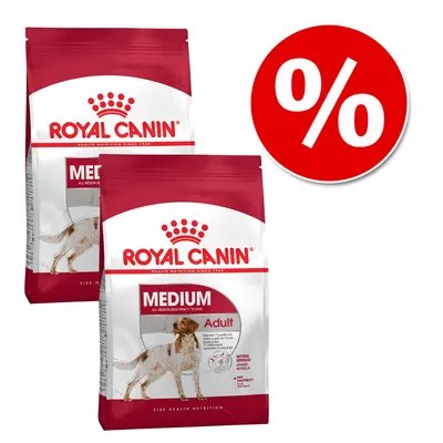 Dwie torby karmy Royal Canin Medium Adult, widoczna nazwa marki i produktu. Czerwone koło z symbolem procenta oznaczającym promocję lub ofertę specjalną.