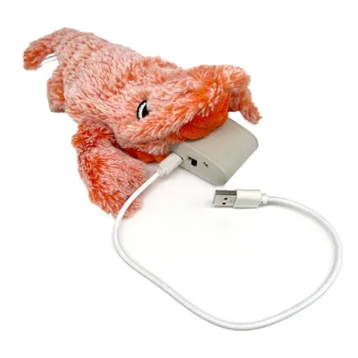 Plyslegetøj i orange med USB-kabel og oplader, egnet til elektroniske funktioner.