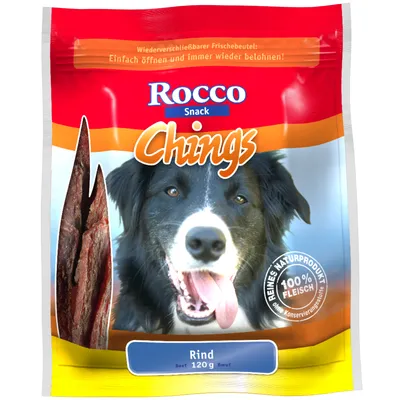 Rocco Snack Chings Rind 120 g, 100% vlees, reines natuurproduct zonder conserveringsstoffen. Afbeelding van hond en stukjes rundvlees op de verpakking.