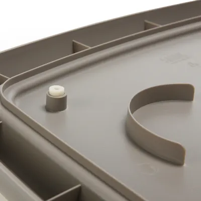 Close-up view of a grey plastic lid with handle and locking mechanism.
