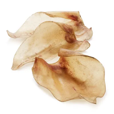 Three natural dried animal ear chews displayed on a white background.