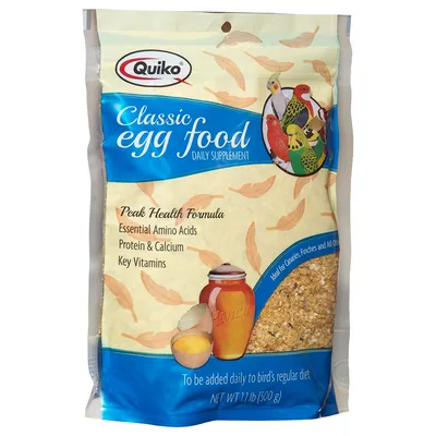 Quiko Classic egg food daily supplement, 500g pack. Visible text: Peak Health Formula, Essential Amino Acids, Protein & Calcium, Key Vitamins. To be added daily to bird's regular diet. Quiko Classic egg food daily supplement, 500g pack. Visible text: Peak Health Formula, Essential Amino Acids, Protein & Calcium, Key Vitamins. To be added daily to bird's regular diet.