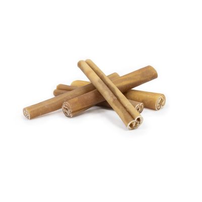 Several rolled-up, brown chew snacks in stick form on a white background.