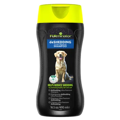 FURminator deSHEDDING ULTRA PREMIUM SHAMPOO, billede af hund på flasken, tekst: HELPS REDUCE SHEDDING, 16.5 oz/490 ml, Bath & Grooming, flere sprogvarianter af produktnavnet synlige.