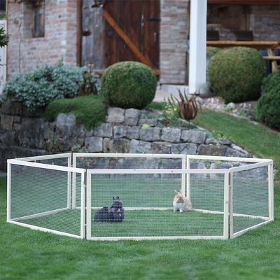 Šesťuholcová vonkajšia ohrada z kovu s mrežovanými stenami na lúke. Dve viditeľné králiky v ohrade.