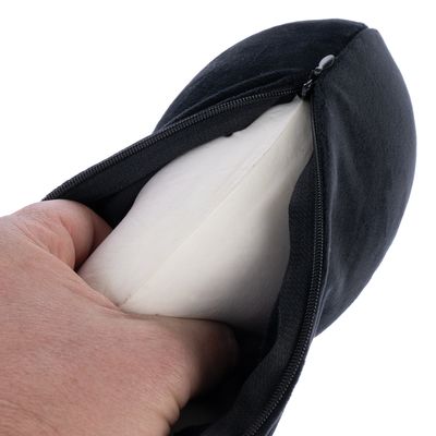 Close-up of a hand removing a white inner cushion from a black cover with zip.