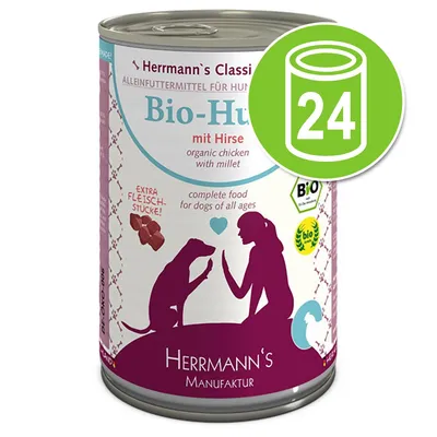 Herrmann's Manufaktur Bio-Huhn mit Hirse, compleet hondenvoer met extra vleesstukken. 24-blik voordeelverpakking zichtbaar op het etiket. BIO-keurmerk aanwezig.