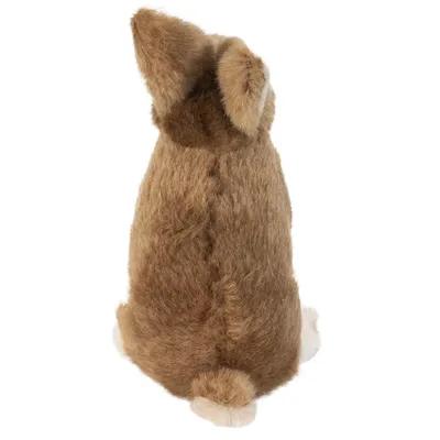 Giocattolo di peluche marrone a forma di coniglio seduto, vista posteriore con orecchie e coda visibili.