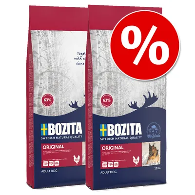 Pachet promoțional cu 2 saci Bozita Original Adult Dog, 12 kg fiecare. Text vizibil: 63 %, 22 % proteină, 11 % grăsime, fără grâu. Simbol procent de reducere pe fundal roșu.