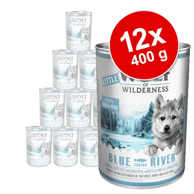 Pack de 12 latas de 400 g de Little Wolf of Wilderness Blue River, texto visible: 100% grain-free, BLUE RIVER, imagen de paisaje y lobo en la etiqueta.