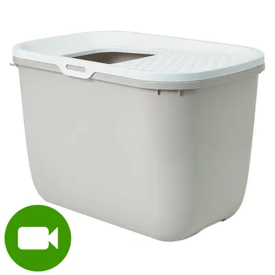 Plastikowa kuweta z białą pokrywą i otworem na górze. W lewym dolnym rogu zielona ikona kamery wideo. Plastikowa kuweta z białą pokrywą i otworem na górze. W lewym dolnym rogu zielona ikona kamery wideo.