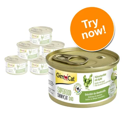 GimCat SUPERFOOD SHINYCAT DUO tinned cat food, visible text: Hühnerfilet mit Apfel, Try now! Orange badge, six tins shown with green apple image on label.