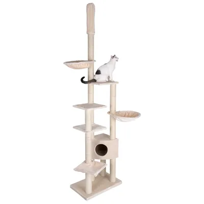 Rascador beige para gatos con varias plataformas, dos camas redondas, una caseta y postes de sisal; un gato blanco y negro está sentado en una de las plataformas superiores.