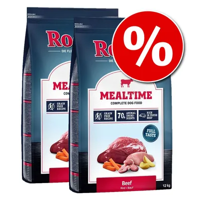 Два пакета Mealtime Complete Dog Food Beef 12 кг с изображение на месо и зеленчуци, надписи: Grain Free Recipe, 7% Animal Ingredients, Rich in Fresh Beef. Червен знак за процентна отстъпка.