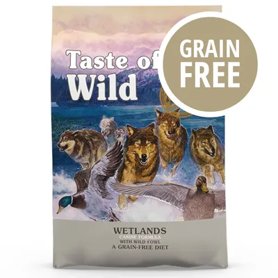 Taste of the Wild Wetlands, scritta 'GRAIN FREE' in evidenza. Testo visibile: Canine Formula with Wild Fowl, A Grain-Free Diet.