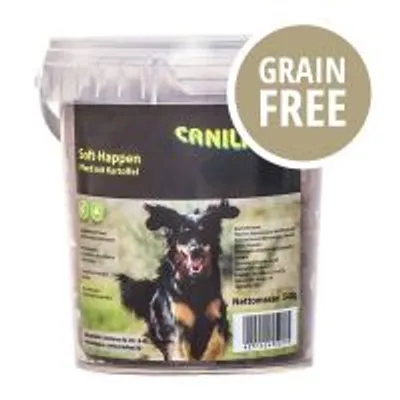 Secchiello CANILIND Soft Happen, testo visibile: 'Grain Free', immagine di un cane nero sulla confezione. Testo aggiuntivo in tedesco non completamente leggibile.